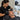 A professional esthetician precisely applying wax to a client's eyebrow to prevent spreading.