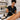 Close up of a professional waxing service showing a single-use wooden spatula applying wax to a client's skin, emphasizing no double dipping for hygiene.