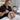 Esthetician applying facial product with headband and barrier cream to protect client hairline during spa treatment