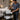 A well-organized spa rolling cart featuring various tall bottles safely secured and upright, preventing them from falling.