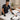 A professional waxing treatment table set up with clean white linens and a brown waxing pad used to prevent wax from sticking to the sheets.
