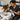 Technician draining a portable foot bath in a professional spa setting demonstrating proper sanitation techniques
