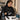 Professional hair clipper guard being sanitized in a disinfectant solution on a salon counter with cleaning tools