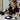 Professional makeup airbrush cleaning process with cleaning solution and tools on a salon workspace.