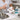 Close up image of a professional nail brush being sanitized in a clear disinfectant solution, representing proper salon hygiene and tool care for nail technicians.