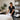 A serene and organized spa treatment room featuring a pristine massage table, a well-stocked cart with towels and professional supplies, and a calm ambiance ideal for a quick and respectful room reset without disturbing a colleague's belongings.