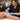 Close up of professional wax application on a client leg, highlighting safe waxing techniques on sun-kissed summer skin with soothing aloe nearby