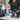 Salon professional sanitizing a plastic combing cape with disinfectant spray on a clean work station