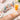 A split image showing a hand with sunscreen pilling into small white balls on one side, and a hand smoothly applying sunscreen with a flawless finish on the other, with spa products and a retail display in the soft-focus background.
