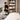 Professional storage of clean, fluffy white spa towels and linens organized neatly on open shelves, symbolizing hygiene and freshness.