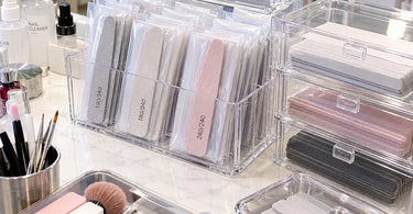 Professional nail salon storage setup with organized nail files and buffers protected from filing dust in a clean manicure workstation