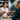 A serene spa professional in a white coat confidently discussing product ingredients with a client, with clean beauty products and treatment tools beautifully arranged in the background.