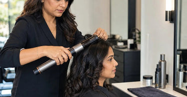 Spa professional testing a new facial steamer on a client in a modern spa treatment room setting