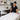 Spa professional demonstrating proper cleaning and sanitation techniques on a facial bed, highlighting Pure Spa Direct's commitment to training staff on cleanliness standards.