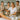 Professional esthetician demonstrating proper waxing technique on client's leg in spa setting