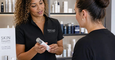 Team of spa professionals gathered in a treatment room for a retail education day, learning about products from Pure Spa Direct.