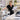 Spa professional organizing and restocking supplies during a cancellation window