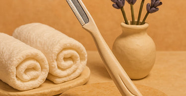 Professional dermaplaning tool on spa towel with skincare products