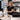 Spa professional cleaning and organizing skincare products and equipment during empty appointment time to maintain a pristine salon environment.