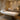 Professional heated massage table in a spa setting with soft lighting and folded towels