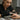 Close-up of a nail technician applying nail forms for acrylic extensions on a client's natural nail