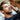A male client receiving an eyelash tint treatment at a spa, with the technician applying tint carefully to his lashes.