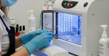 A clean and organized nail salon workspace with sterilized tools and products