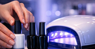 A professional nail technician curing a client's gel polish under a modern UV LED lamp in a clean, well-equipped salon setting.