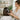 Professional hairstylist applying a formaldehyde-free keratin smoothing treatment to a client's hair in a modern salon