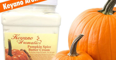 Large 64 oz tub of Keyano Aromatics Pumpkin Spice Butter Cream on a spa table with autumn leaves and a wooden scoop for professional body treatments.