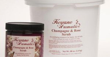 Keyano Champagne and Rose Scrub 80 oz tub with pink label and silver lid on a white surface