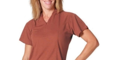 Model wearing the Ladies Siena Uniform Top by Yeah Baby, a navy blue mock-wrap tunic with a zipper front, ideal for spa and salon professionals.