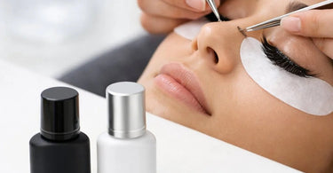 Professional lash artist applying eyelash extensions using latex-free and fume-free adhesive in a well-equipped salon