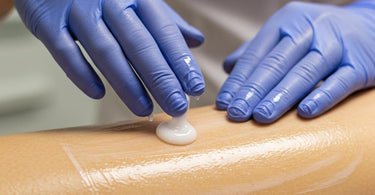 A soothing lotion being applied to smooth, freshly waxed skin
