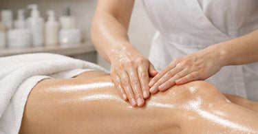 A spa professional performing a gentle lymphatic drainage massage on a client's neck and d&eacute;colletage using lightweight oil
