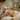 A professional esthetician performing gentle lymphatic drainage massage techniques on a client's face and neck in a serene spa setting