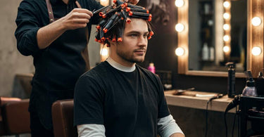 Male client receiving a wavy perm at a barber shop