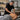 A serene spa setting with a massage table, warm towels, and essential oils, symbolizing professional post-treatment care and client comfort for managing delayed onset muscle soreness.