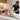 A serene prenatal massage setup showcasing a side-lying client on a massage table with bolsters and a therapist providing gentle, professional care in a calm spa environment.