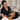 A professional esthetician applying a high-quality hard wax to a client's bikini line, focusing on proper technique to prevent ingrown hairs for those with tight curl patterns. The image showcases a clean and professional spa setting.