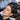 Close-up of a hairstylist's hands gently applying a soothing primer to a client's scalp before a hair color service in a salon