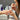 Nail technician applying strengthener to client's nails