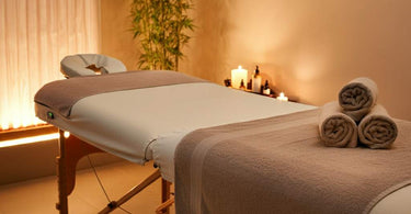 Heated massage table with soft linens in a tranquil spa setting