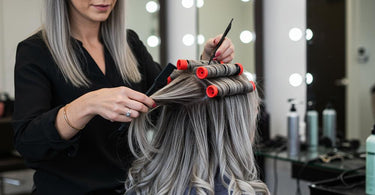 Stylist perming gray hair in a salon