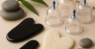 Professional myofascial tools including Gua Sha instruments and cupping sets arranged on spa towel