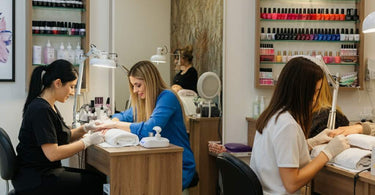 A modern nail salon featuring elegant nail stations and pedicure chairs