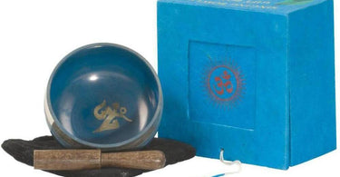 Nature's Artifacts Tibetan Singing Bowl with Gift Set displayed on a spa counter with a wooden striker and cushion for sound healing therapy