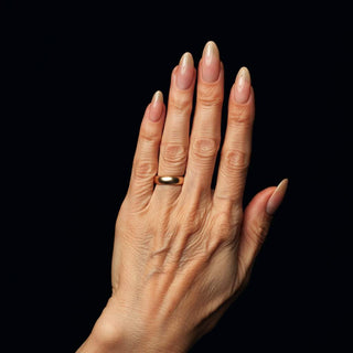 Neutral manicure on older hand, demonstrating a flattering oval nail shape.