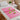 Miss Cire Pink Pre-Cut Waxing Paper rolls displayed neatly on a spa table