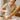 Professional esthetician performing a pain-free waxing treatment on a client